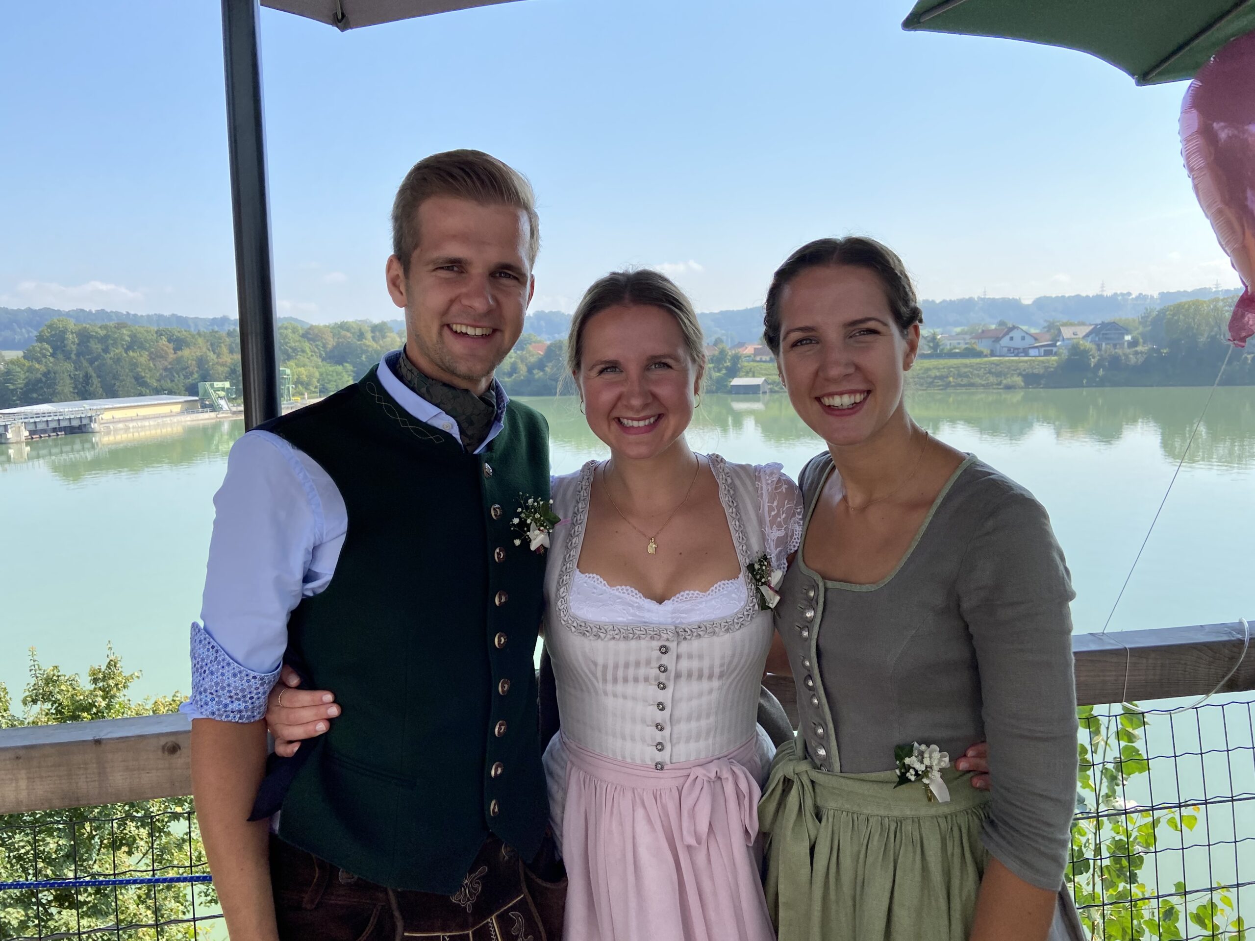 Portrait of Eva, Helge, and Gabi standing together on the terrace
