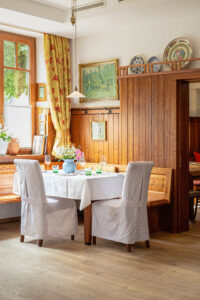 Cozy wooden dining room with decorated walls and traditional seating
