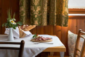 Traditional dining table set with roast beef and fresh bread

