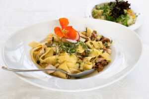 Pasta dish with chanterelle mushrooms and fresh herbs
