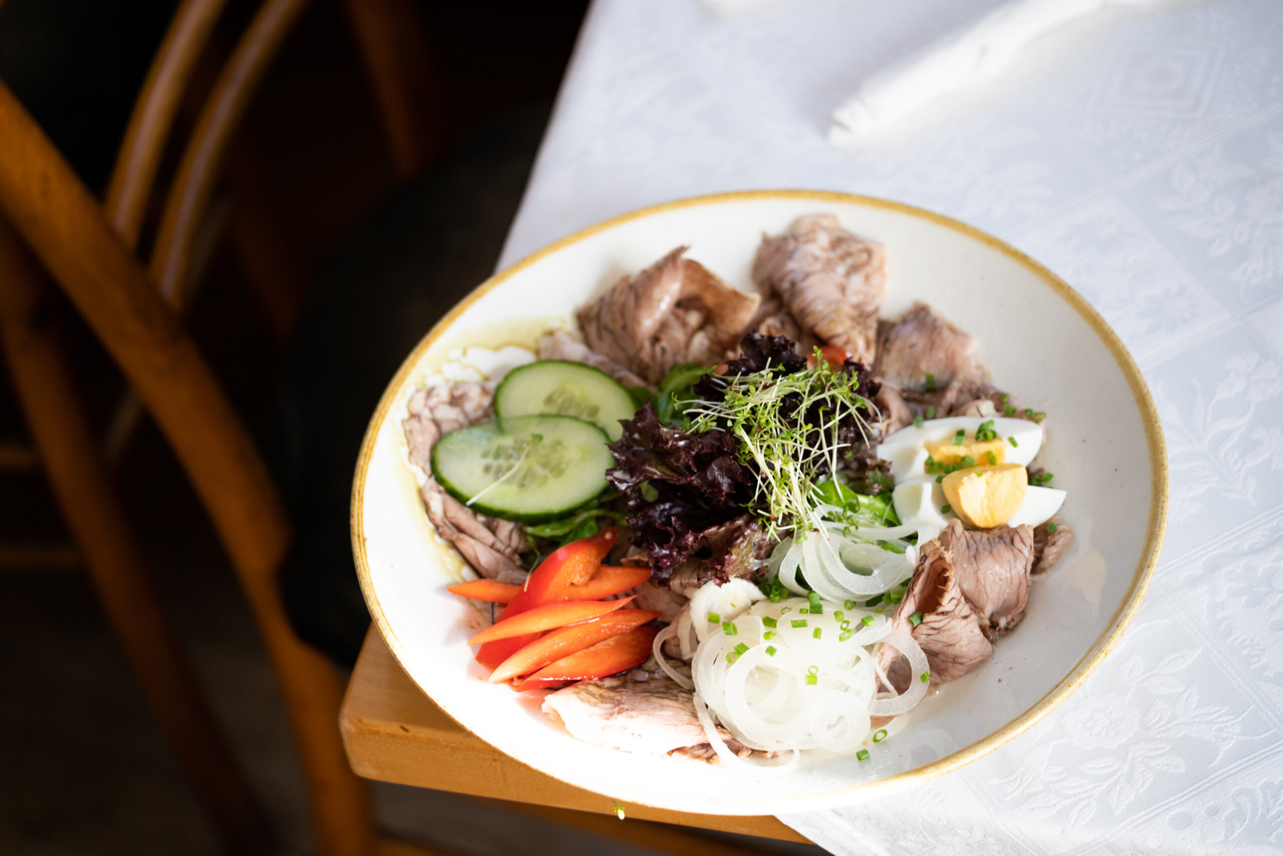 Fresh salad bowl with vegetables, seeds, and dressing
